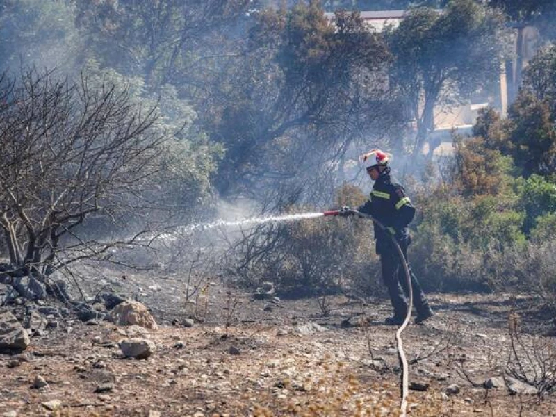 Firefighters in Greece struggle to save coastal resort as winds rage