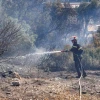 Firefighters in Greece struggle to save coastal resort as winds rage
